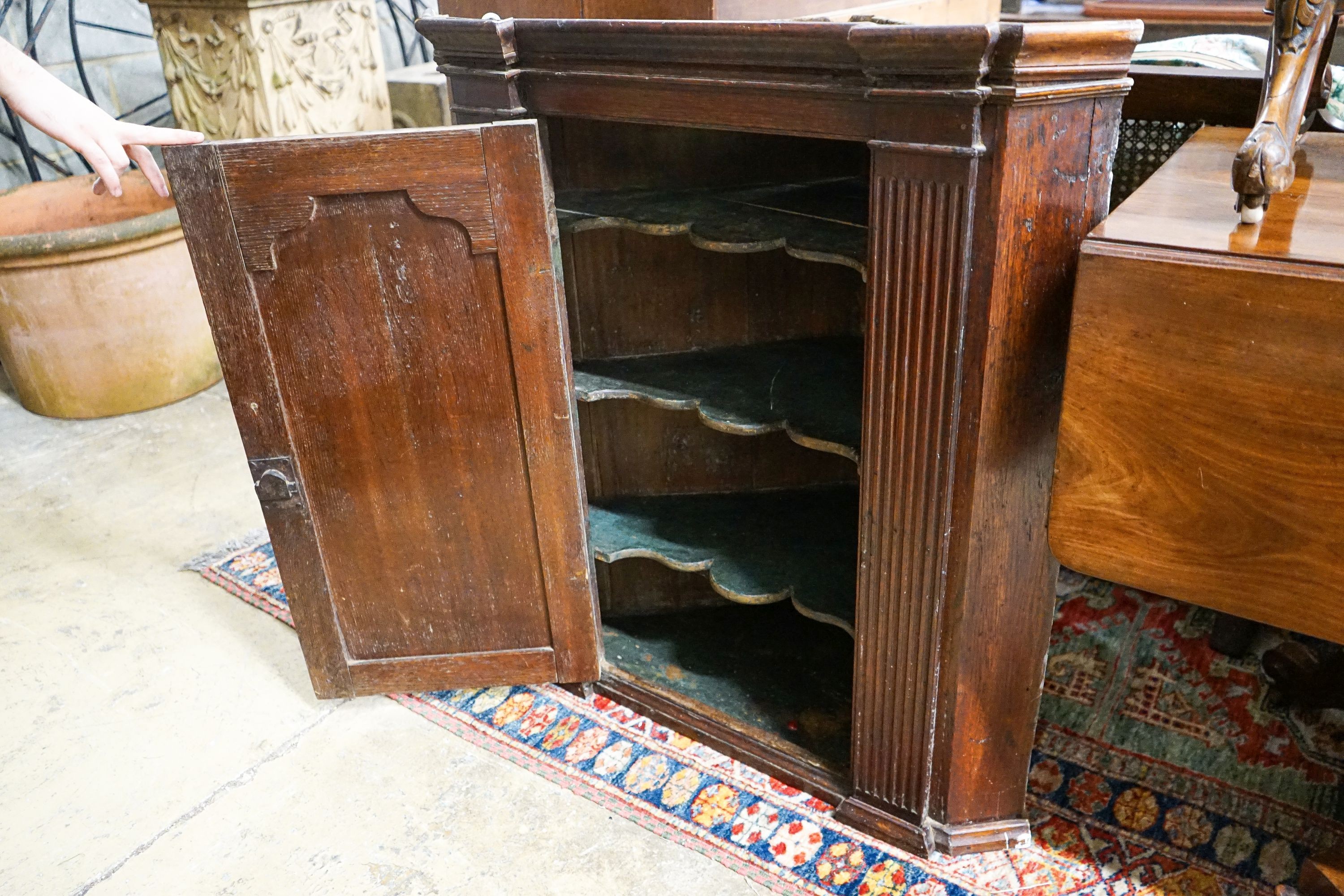 A George III oak hanging corner cabinet, width 80cm, depth 44cm, height 90cm